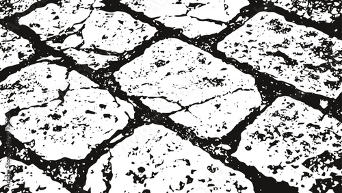 Rough textured stone pavement with cracks and uneven surfaces in black and white