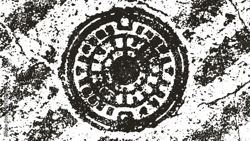 Old metal manhole cover surrounded by worn concrete surface with cracks and stains