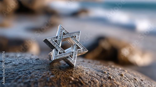 Ornate metallic geometric symbol adorned with sparkling gemstones rests on a wet coastal stone.