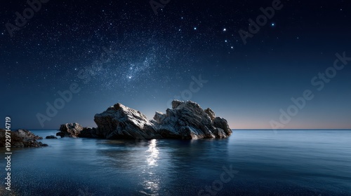 Dark ocean waters surround jagged rocks beneath a bright, star-filled night sky