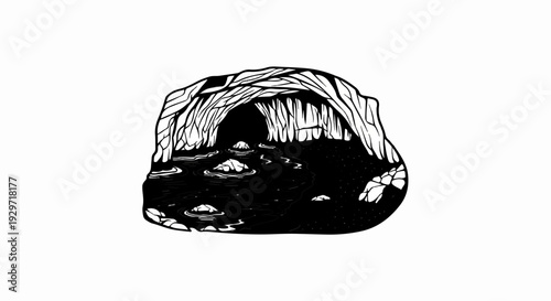 Dark cave opening with water and rocks leading into shadowed depths