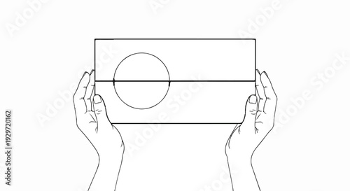 Two hands hold a rectangular object divided into two halves with a circle on the upper half