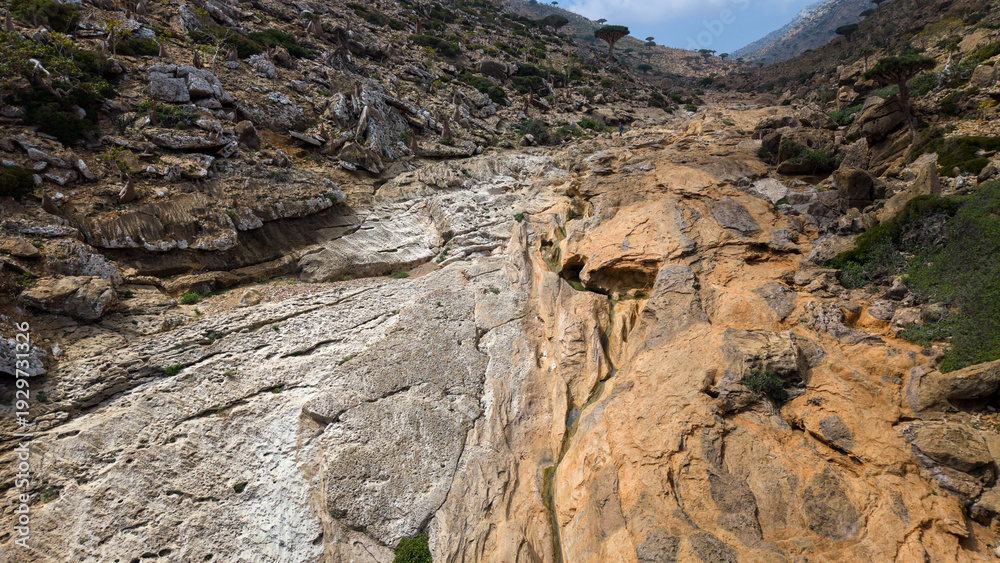Obraz premium Rocky canyon with dry riverbed and eroded sandstone