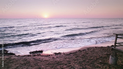 Long Beach at Dawn: Historical Steps and Waves Meeting the Shoreline in Iskele, Northern Cyprus