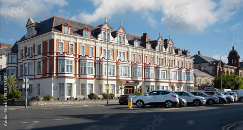 Llandudno north Wales united kingdom 01 August 2022 Seaside Hotel Facade With Victorian Architecture, Bay Windows and Street Parking on Sunny Day