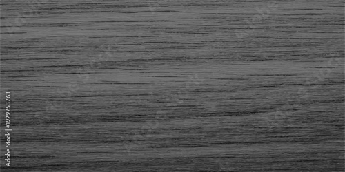 A closeup of dark black and white fabric texture on a rough brown wooden grain plank surface with a natural oak timber board pattern