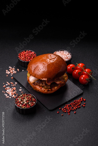 A burger with a patty, cheese, vegetables, and sauce. A burger with meat