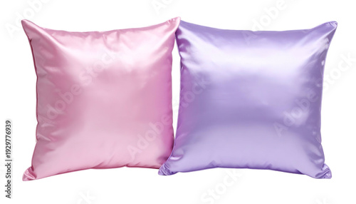 Two square satin pillows, one pink and one lavender, set against a black background