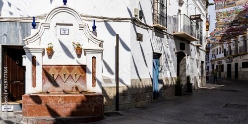 Yunquera, Málaga, Spain. September 29, 2025.- Poyo fountain and Calvario street covered by awnings to provide shade.
