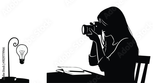 woman taking photo with camera at desk by lightbulb