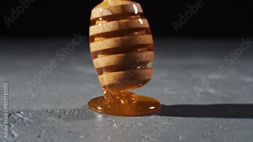 Golden Honey Dripping From Wooden Dipper Onto Textured Surface Studio Lighting
