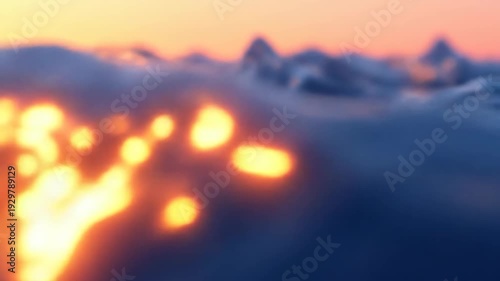 Abstract blue liquid waves reflecting orange light against a soft sunset glow