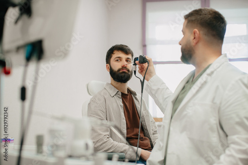Photos Ent doctor performing nasal endoscopy on patient