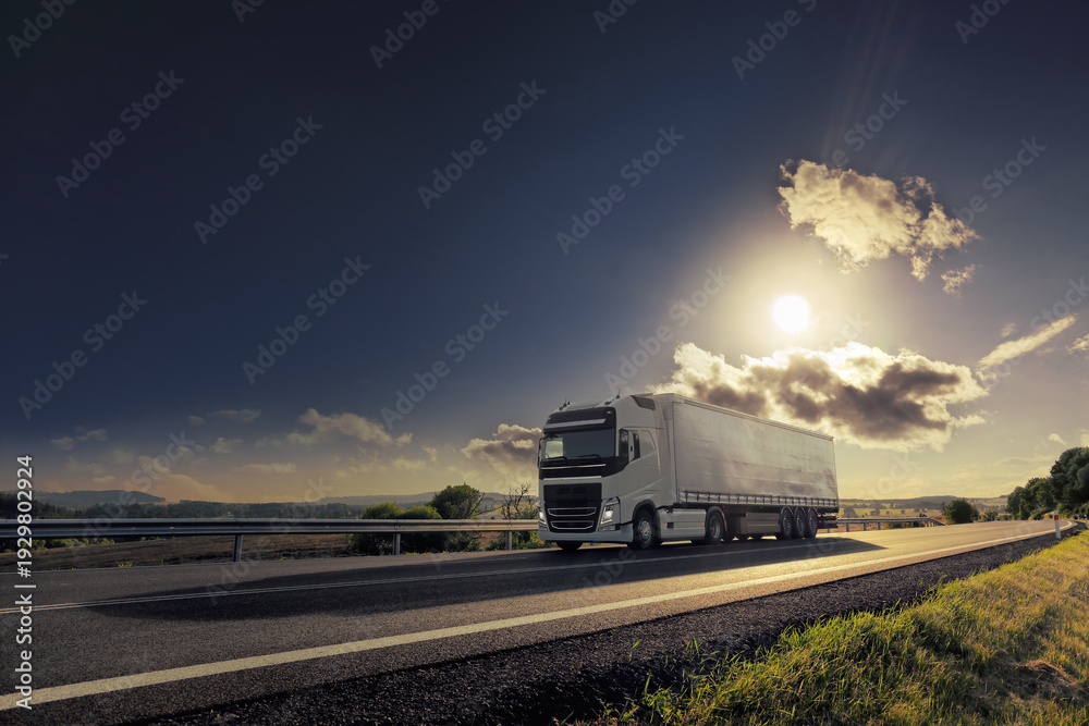 Ταπετσαρία A trucks on a highway at sunset drives through a wide landscape, transporting go