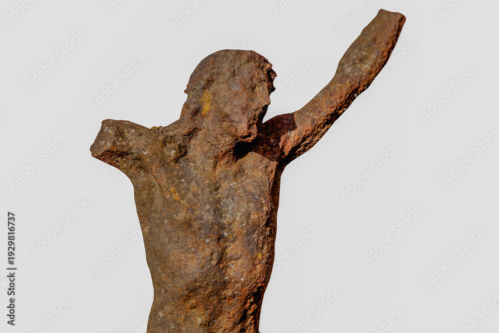 Obraz premium Very old iron statue of the crucifixion of Jesus Christ, rough texture and aged surface, representing endurance, belief, and sacred heritage.