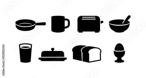 Breakfast table items: frying pan, coffee mug, toaster, cereal bowl, juice glass, butter dish, bread loaf, egg cup