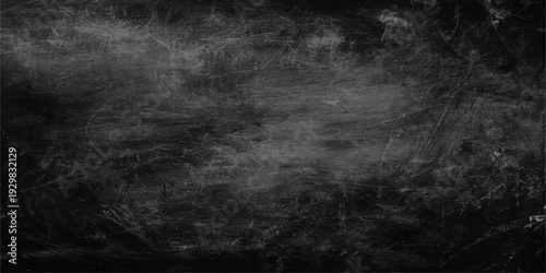 An old dark grunge black and white textured background with a vintage gray concrete wall pattern for a dirty aged surface backdrop design