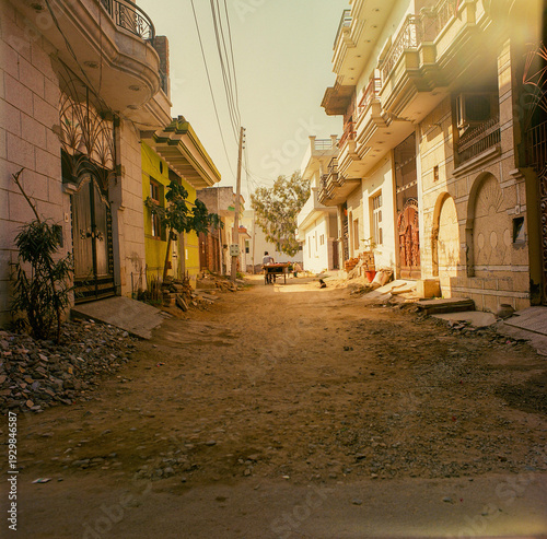 Photography A narrow street with houses on either side