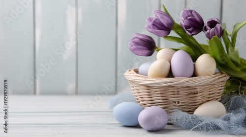Pastel Easter eggs in a wicker basket with purple tulips on a light wooden table, spring holiday still life with copy space.