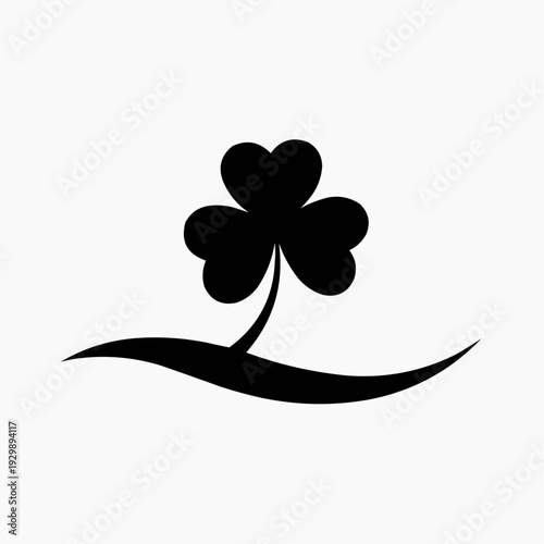 Black shamrock silhouette on a wavy line, symbolizing luck and Ireland.
