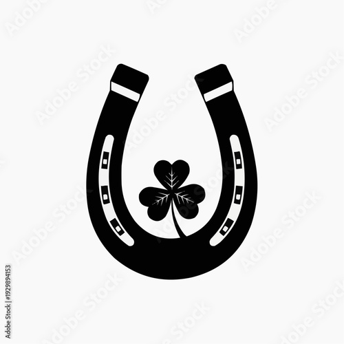 Black horseshoe with a shamrock inside, symbol of luck