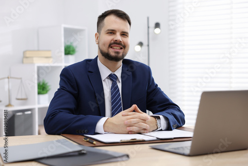 Portrait of notary at wooden desk in office