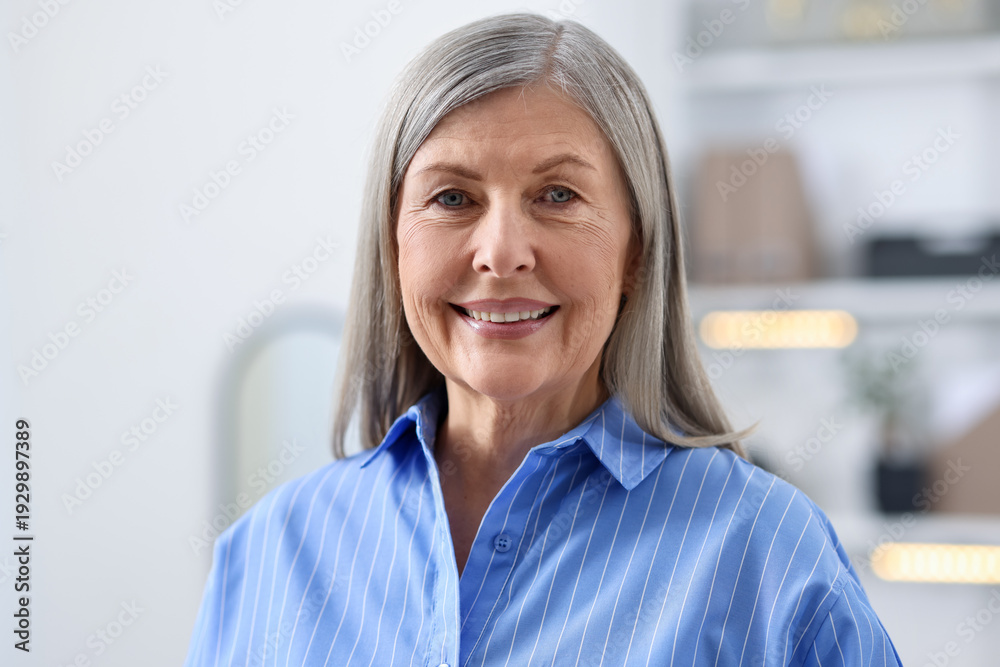 Fototapeta premium Portrait of smiling senior woman at home