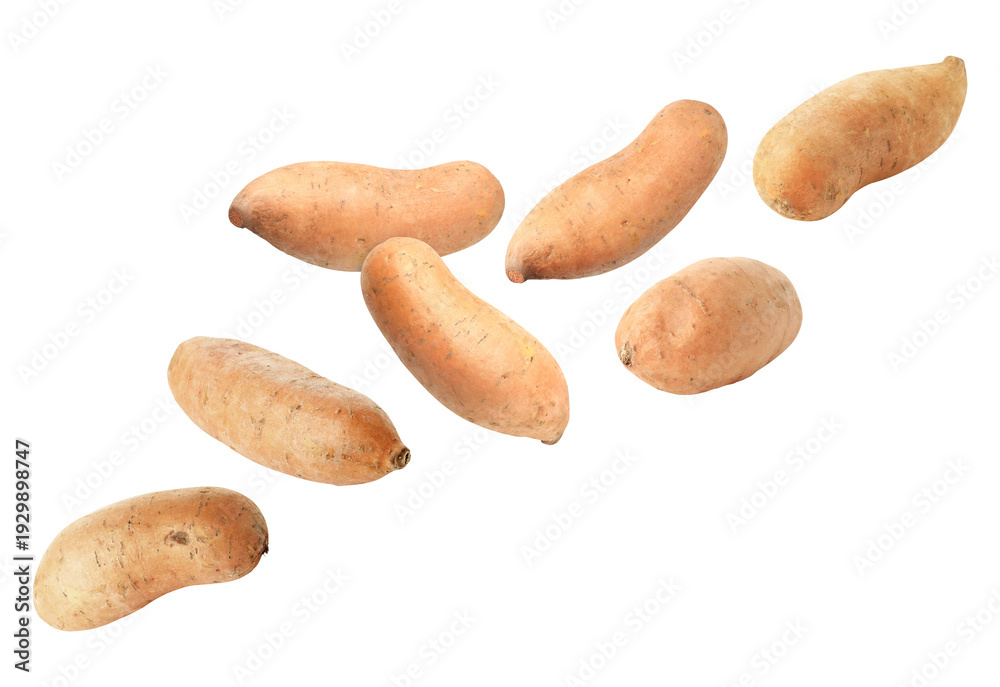 Obraz premium Fresh sweet potatoes falling against white background