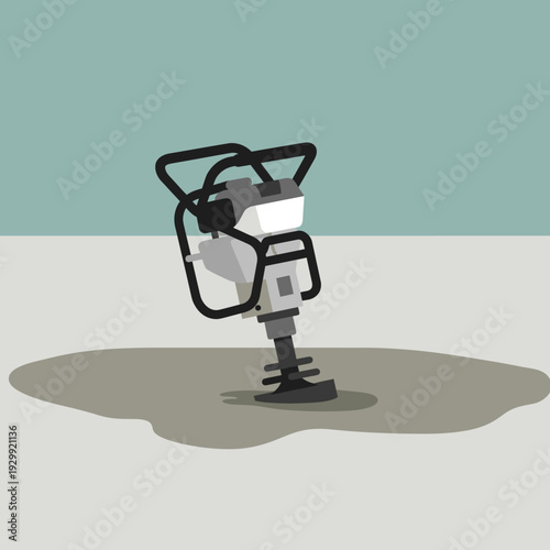 A jumping jack rammer compactor machine on a patch of loose ground, used for soil compaction in construction.