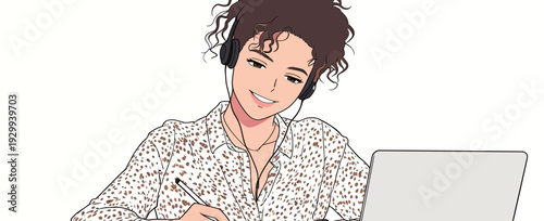 A young woman sits at a desk wearing headphones. She is focused on her laptop and taking notes with a pen in a bright room.