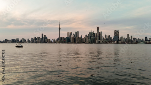 Canvas Print Experience the serene beauty of Toronto's skyline at dusk, with a peaceful boat