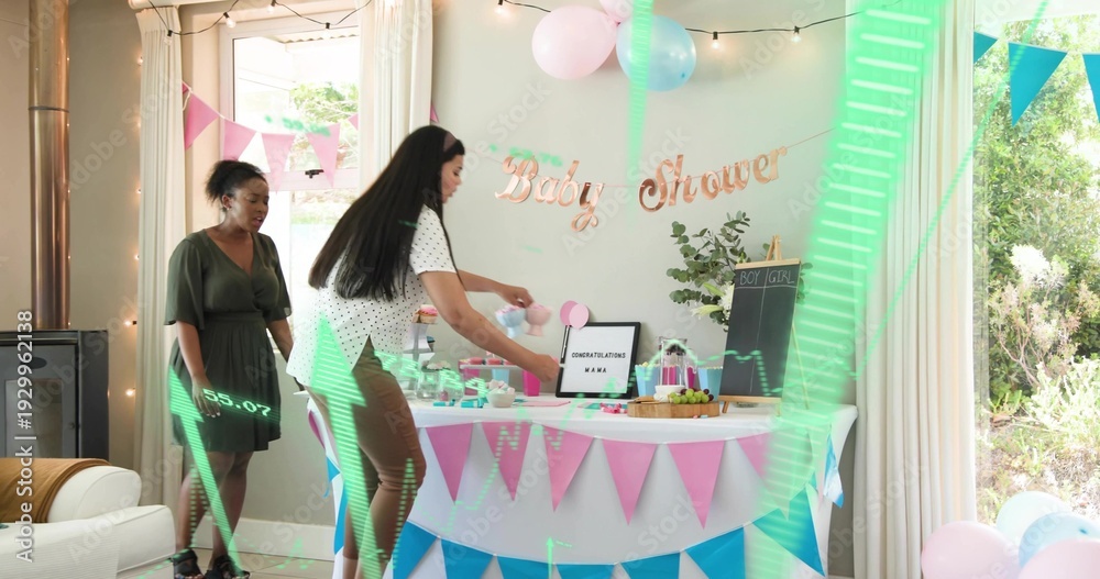 Obraz premium Placing baby shower table at home women wearing white top and green dress arranging bunting cakes
