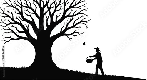 silhouette of man throwing leaves from a basket under bare tree