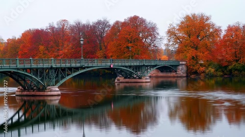 Wallpaper Mural An arched metal bridge spans a calm body of water, flanked by vibrant autumnal foliage Torontodigital.ca