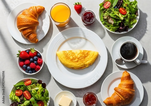 Inviting breakfast with omelette, croissants, coffee and salad spread out