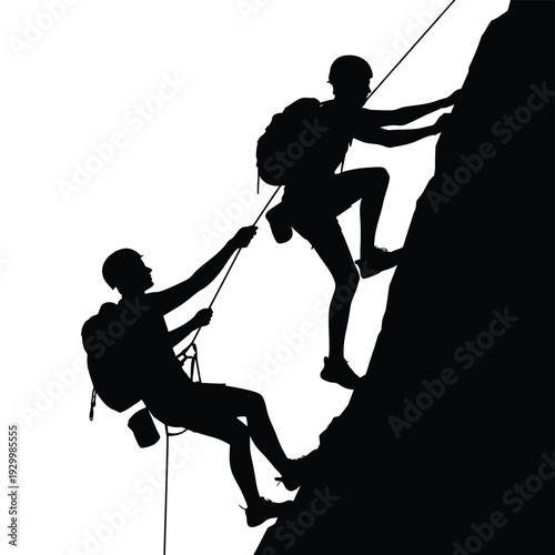 Silhouetted climbers assisting each other during a challenging rock ascent