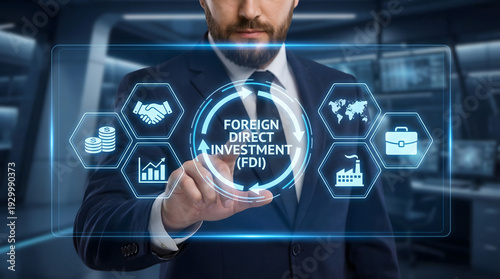 Businessman in suit interacts with Foreign Direct Investment FDI virtual screen in dark high tech bu