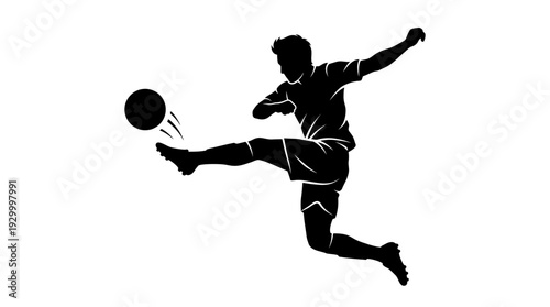 Silhouette of a soccer player kicking a ball in mid air