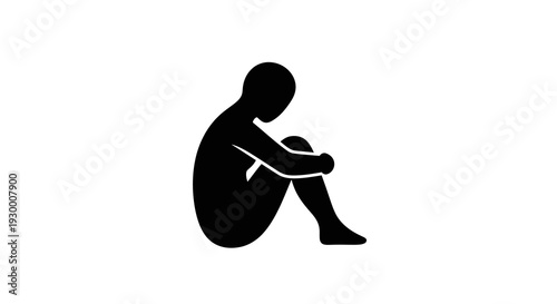 A person sitting alone in contemplation with their head bowed down.