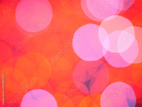 Abstract Bokeh from indoor lighting, Pink with red with orange with gold and yellow circles colored surface, Night city light background for celebration of christmas and holiday season