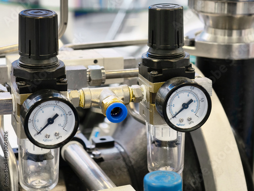 Gauges and regulators showcase precise control in an industrial setting for monitoring pressure levels