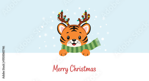 Adorable tiger cub wearing reindeer antlers and a green scarf peering over a snowy border for Christmas wishes.