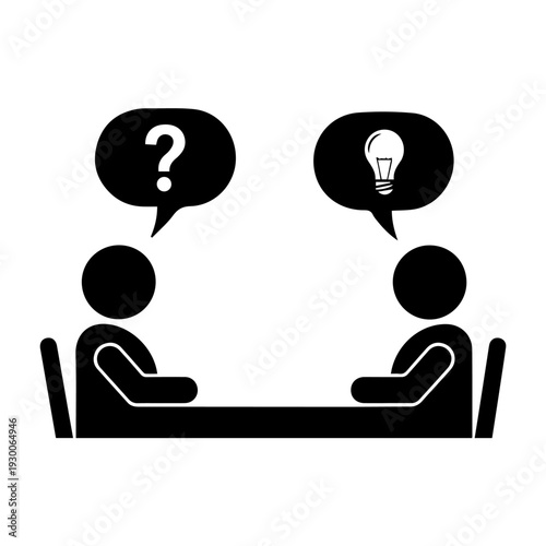 Two people discussing ideas across a table in a meeting room setting