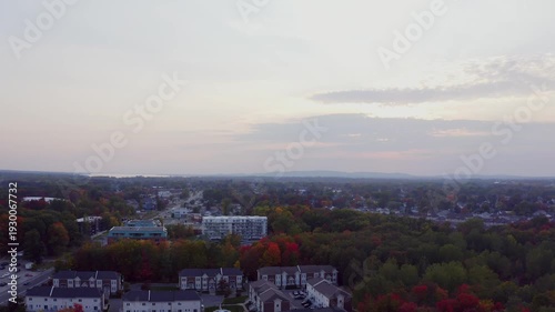Panning from right to left over the city in Fall during a foggy and cloudy day.