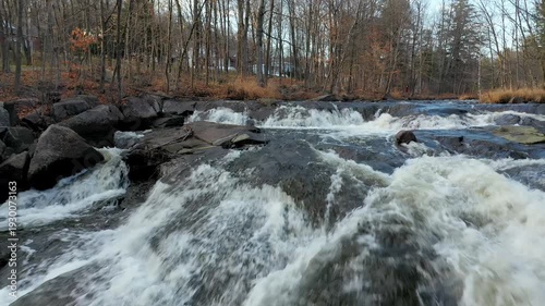 Drone flying at very low altitude over the rivers near the rapids and following the river going upstream.