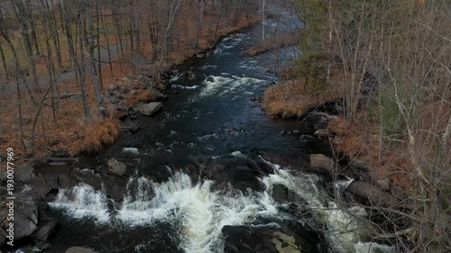 Drone crane shot coming down over the rapids in the Fall on a beautiful day.