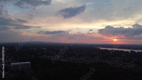 Flying from left to right, with a drone, way above the city at sundown