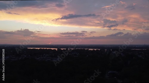Time lapse with a drone. Flying way above the city at sundown