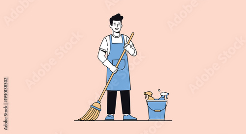 Professional cleaning man wearing an apron and holding a broom standing next to a bucket filled with cleaning sprays and supplies.