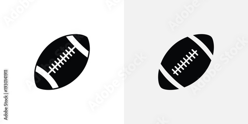 Two black and white American footballs on a plain background for sports design